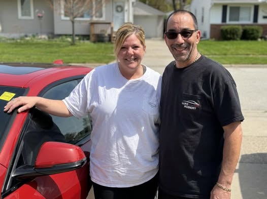 Robert and Stefanie, the owners of Luxe Carpet Cleaning and Luxe Clean Living, standing beside their work vehicle